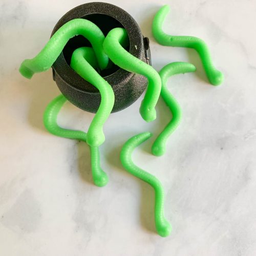 Green candy worms in cauldron