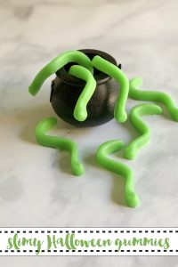 Green gummy worms in a cauldron