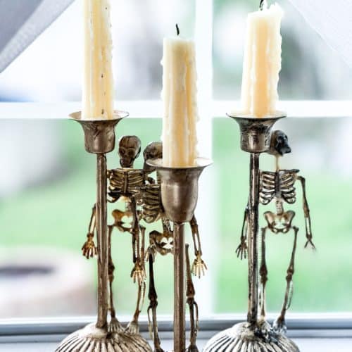 Make these spooky skeleton candlesticks with less than $10 and 10-minute DIY from Everyday Party Magazine #Skeleton #DollarStoreCrafts #Halloween #DIY